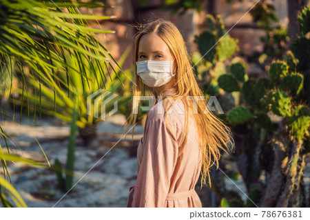 beautiful stylish young woman in pink dress in desert among the cacti, wearing a medical mask during COVID-19 coronavirus, traveling in Africa on safari, exploring nature, sunny summer, traveler on beautiful stylish young woman in pink dress in desert among the cacti, wearing a medical mask during COVID-19 coronavirus, traveling in Africa on safari, exploring nature, sunny summer, traveler on 78676381