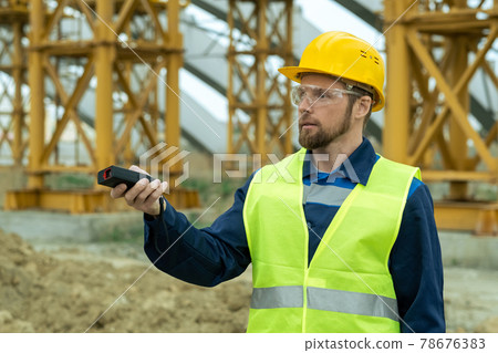Young builder in uniform working at construction site Young builder in uniform working at construction site 78676383