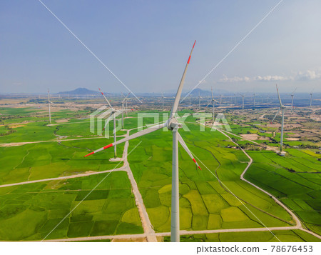 Wind power plant. green meadow with Wind turbines generating electricity 78676453