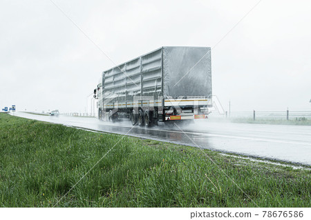 The movement of trucks of trucks with a semi-trailer and cars on a wet road in rain and fog and in poor visibility. Road safety concept. Copy space for text 78676586