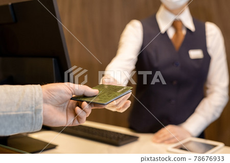 Hand of mature man taking back his passport Hand of mature man taking back his passport 78676933