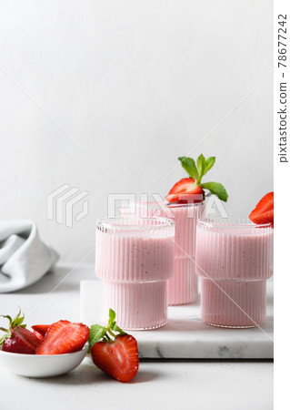 Indian strawberry lassi or milkshake on white background Indian strawberry lassi or milkshake on white background 78677242