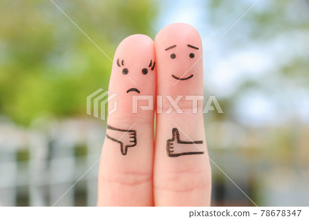 Fingers art of couple. Woman showing thumb down and man showing thumb up.  78678347