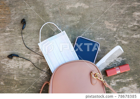 Things from open lady handbag. Concept of protect yourself from COVID-2019. Top view. 78678385