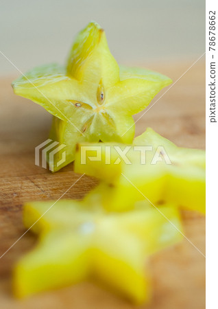 Exotic starfruit or averrhoa carambola on wooden cut board. Healthy food, fresh organic star apple fruit. Exotic starfruit or averrhoa carambola on wooden cut board. Healthy food, fresh organic star apple fruit. 78678662