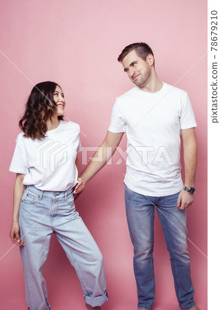 young cheerful caucasian couple together having fun on pink background, guy ang girl modern relationship, lifestyle people concept 78679210
