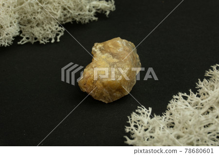 Chalcedony from Madagascar. Natural mineral stone on a black background surrounded by moss. Mineralogy, geology, magic, semi-precious stones and samples of minerals. Close-up macro photo Chalcedony from Madagascar. Natural mineral stone on a black background surrounded by moss. Mineralogy, geology, magic, semi-precious stones and samples of minerals. Close-up macro photo 78680601