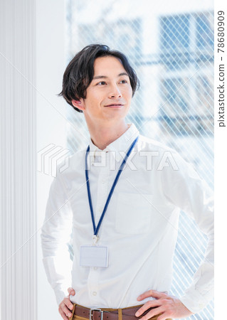 Business image of a man standing in the office Business image of a man standing in the office 78680909