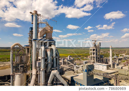 Aerial view of cement factory with high concrete structure and tower crane at industrial production area. Manufacture and global industry concept. Aerial view of cement factory with high concrete structure and tower crane at industrial production area. Manufacture and global industry concept. 78680989