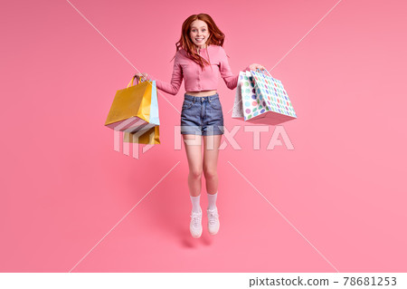 Cheerful trendy stylish carefree woman rejoicing with sales, shopping time, isolated 78681253