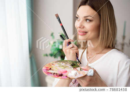 Art, creativity, job and creative occupation concept. Female artist posing in front of window and 78681438