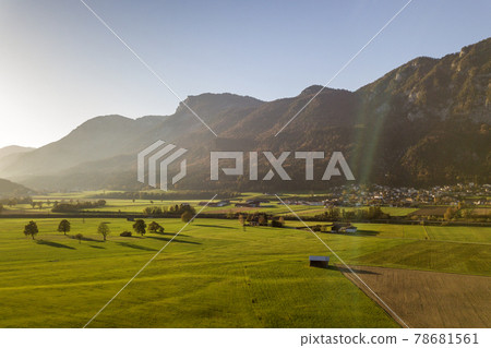 Aerial view of green meadows with villages and forest in austrian Alps mountains. 78681561