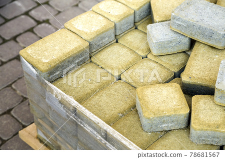 Installation of stone paving slabs in a yard. Installation of stone paving slabs in a yard. 78681567