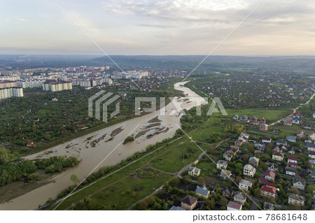 Aerial view of Ivano-Frankivsk city with residential area and suburb houses with a river in middle. 78681648