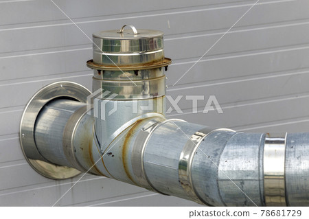 Metallic exhaust smoke pipes installed on house exterior wall. Metallic exhaust smoke pipes installed on house exterior wall. 78681729