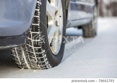 Close-up of car wheels rubber tire in deep snow. Transportation and safety concept. Close-up of car wheels rubber tire in deep snow. Transportation and safety concept. 78681793