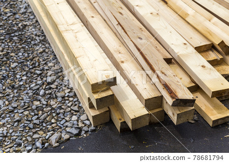 Stack of natural wooden boards on building site. Industrial timber for carpentry, building or repairing, lumber material for roofing construction. Stack of natural wooden boards on building site. Industrial timber for carpentry, building or repairing, lumber material for roofing construction. 78681794