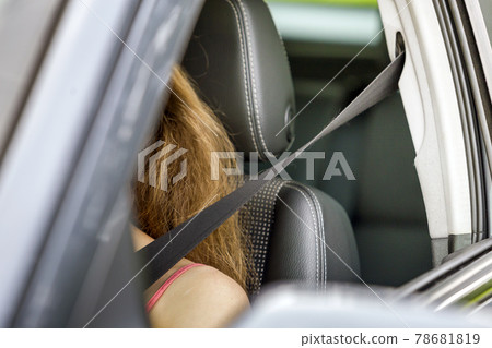 Young woman inside vehicle wearing protective seat belt. Safety and precaution concept. Young woman inside vehicle wearing protective seat belt. Safety and precaution concept. 78681819