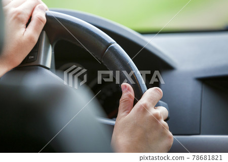 Woman hands on steering wheel driving a car. Woman hands on steering wheel driving a car. 78681821