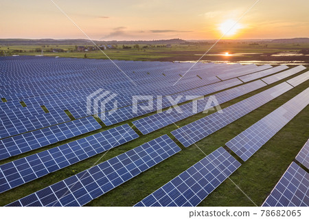 Blue solar photo voltaic panels system producing renewable clean energy on rural landscape and setting sun background. Blue solar photo voltaic panels system producing renewable clean energy on rural landscape and setting sun background. 78682065