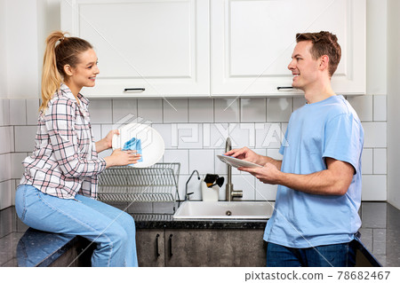 Cheerful Caucasian Couple Washing Dishes Together Indoors, Keeping House Tidy Cheerful Caucasian Couple Washing Dishes Together Indoors, Keeping House Tidy 78682467