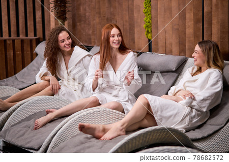 Friendly nice women amusing each other, laughing in spa center 78682572