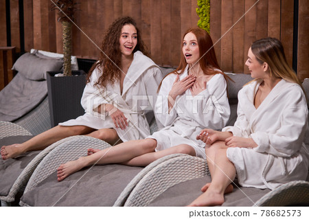 Three young caucasian women relaxing in spa and wellness center together, having conversation 78682573