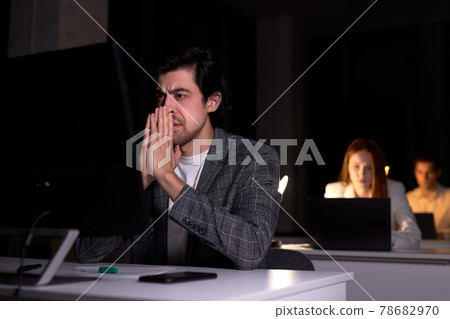 Portrait of exhausted serious caucasian male worried by work on computer 78682970