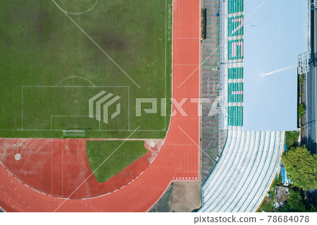 Aerial view of empty green football field with running track Empty stadium view from top. Aerial view of empty green football field with running track Empty stadium view from top. 78684078