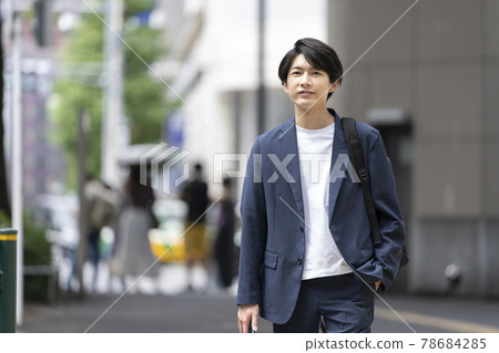 Young man walking in the city Young man walking in the city 78684285