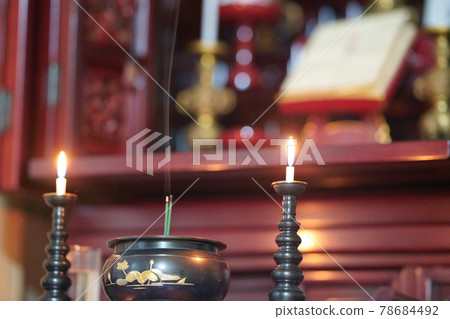 Buddhist altar with candles and incense sticks 78684492