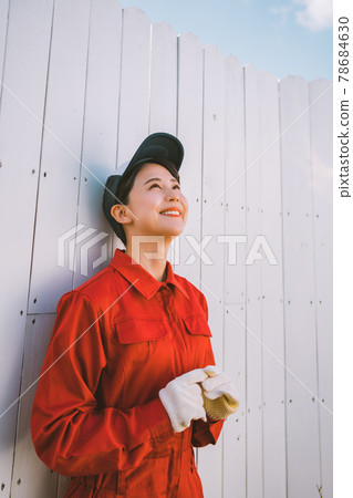 Young woman in red jumpsuit Young woman in red jumpsuit 78684630