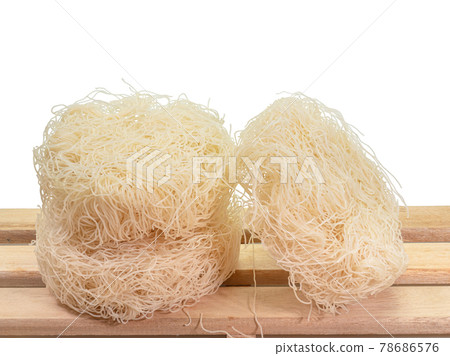 Old pot rice noodles, a close up of Taiwanese instant dried thin noodle food with wooden board isolated on white background. Old pot rice noodles, a close up of Taiwanese instant dried thin noodle food with wooden board isolated on white background. 78686576