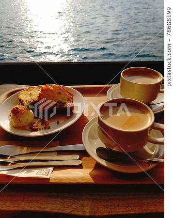 Coffee by the window by the sea illuminated by the sun Coffee by the window by the sea illuminated by the sun 78688199