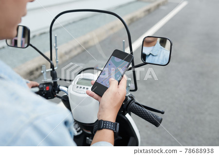 Moped Driver Navigating with Online App Moped Driver Navigating with Online App 78688938