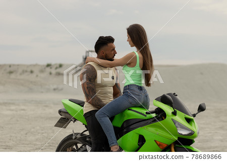 Stylish couple on motorbike on beach 78689866