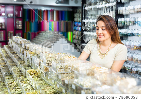 Hispanic woman choosing bijouterie in jewelry accessories store Hispanic woman choosing bijouterie in jewelry accessories store 78690058