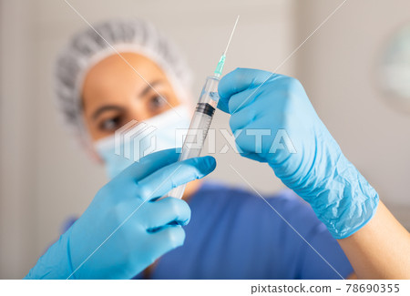 Syringe for injection in doctor hands 78690355