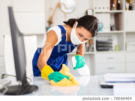 Female cleaner working in protective mask productively on task Female cleaner working in protective mask productively on task 78690464