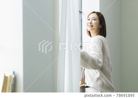 A woman basking in the morning sun A woman basking in the morning sun 78691895