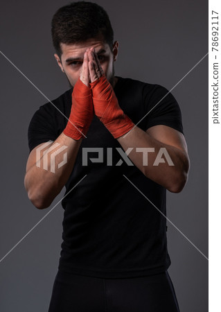 Young MMA fighter with hands folded for praying Young MMA fighter with hands folded for praying 78692117