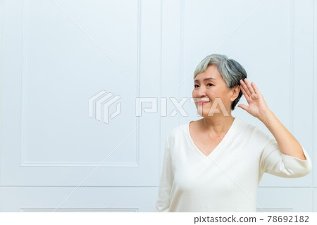一位銀髮白髮的年長婦女在落地窗旁 一位銀髮白髮的年長婦女在落地窗旁 78692182