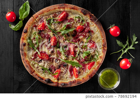 Top view of pizza with cabanossi, salami, bacon, ham and parmesan Top view of pizza with cabanossi, salami, bacon, ham and parmesan 78692194