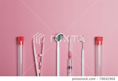 Medical instruments, devices and items on the colored table in the hospital. Syringe, test tube, tweezers. Healthcare, medicine, treatment and doctors concept Medical instruments, devices and items on the colored table in the hospital. Syringe, test tube, tweezers. Healthcare, medicine, treatment and doctors concept 78692968