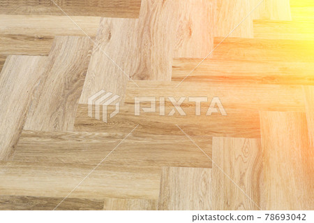 Laminate and parquet with herringbone background. Wooden floor with a chevron pattern in the living room of the designer interior 78693042