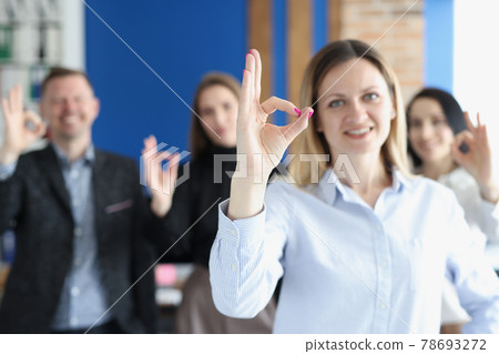 Business people team shows ok gesture in office Business people team shows ok gesture in office 78693272