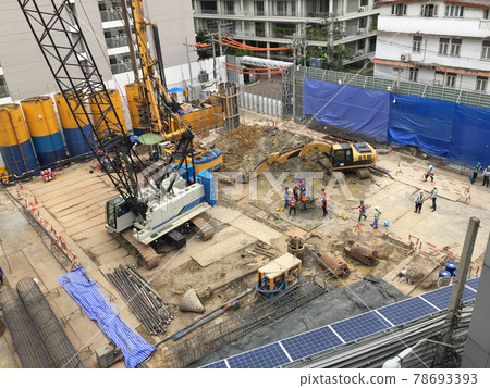 Workers in the construction area with a crane truck and holding machine Workers in the construction area with a crane truck and holding machine 78693393