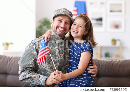 Happy young father in military uniform reunited with cute little daughter at home 78694295