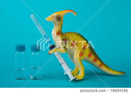 minimal concept of vaccination against coronavirus, protection against extinction of the population, a toy dinosaur holds a syringe and a vaccine stands nearby minimal concept of vaccination against coronavirus, protection against extinction of the population, a toy dinosaur holds a syringe and a vaccine stands nearby 78694386