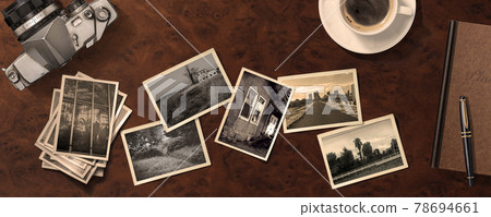 Old photos lined up on an antique table. Angle from directly above 78694661